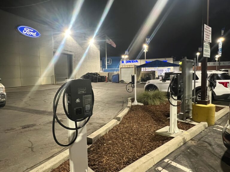 Wide view of the designated parking area with new EV charging stations.
