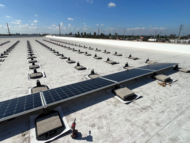 Wide overhead shot showing the extensive solar panel coverage on Public Storage units.