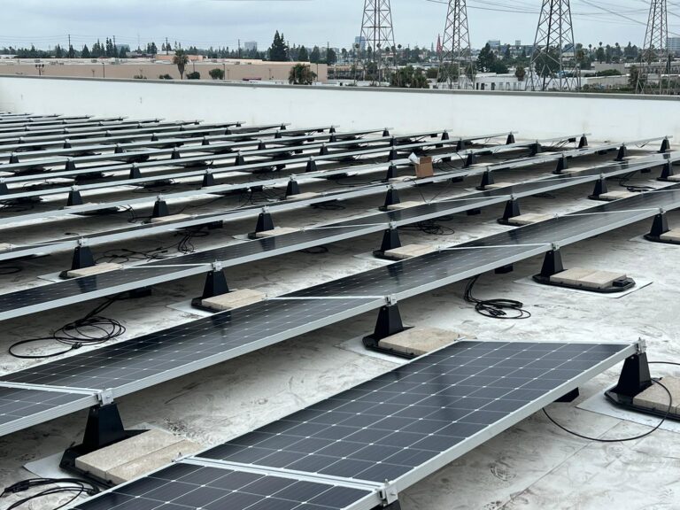Solar panels and electrical connections on the Public Storage facility roof.