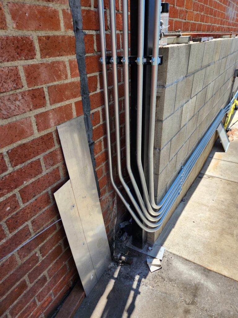 Wide view of the designated parking area with new EV charging stations.