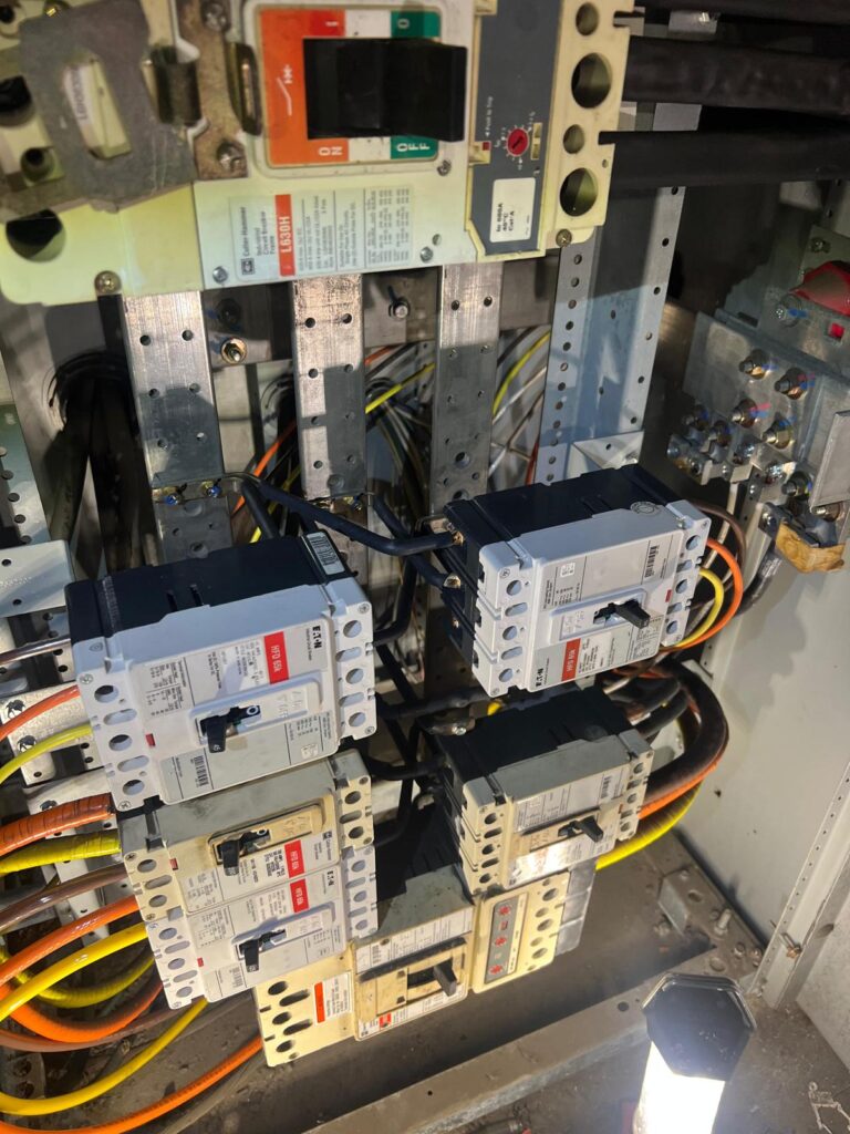 Vertical shot showing the electrical conduit and wiring path for the new EV chargers.