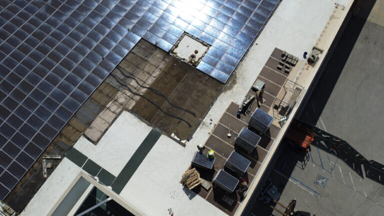 Close-up of solar panels being mounted on the Macy's store rooftop.