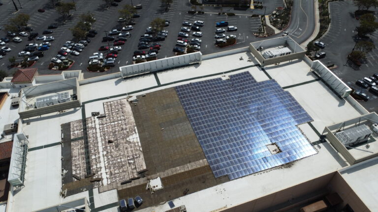 Close-up of solar panels being mounted on the Macy's store rooftop.
